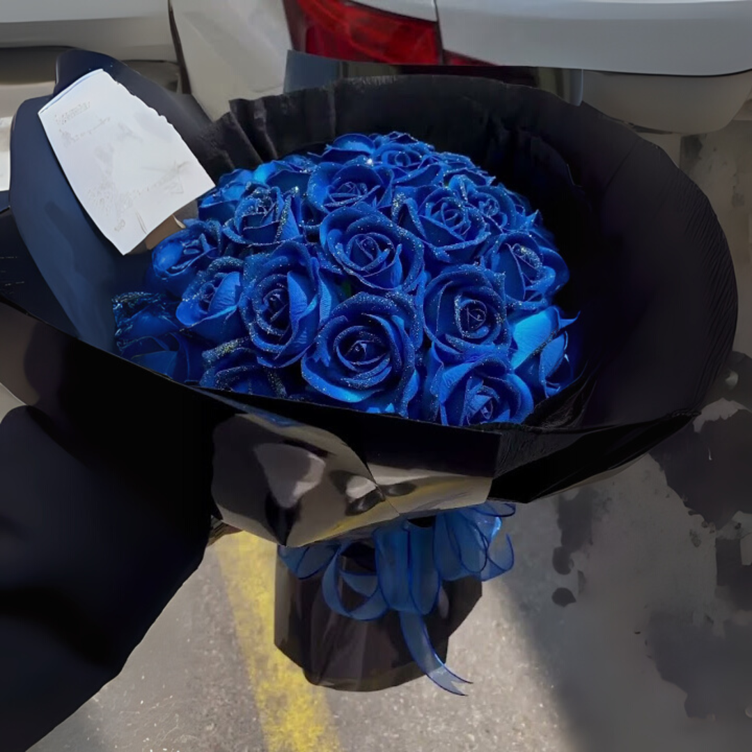 Preserved roses gift box with blue roses in black wrap, outdoors