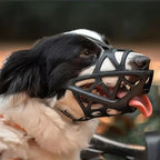 Black mesh dog muzzle close-up with secure straps and open basket design