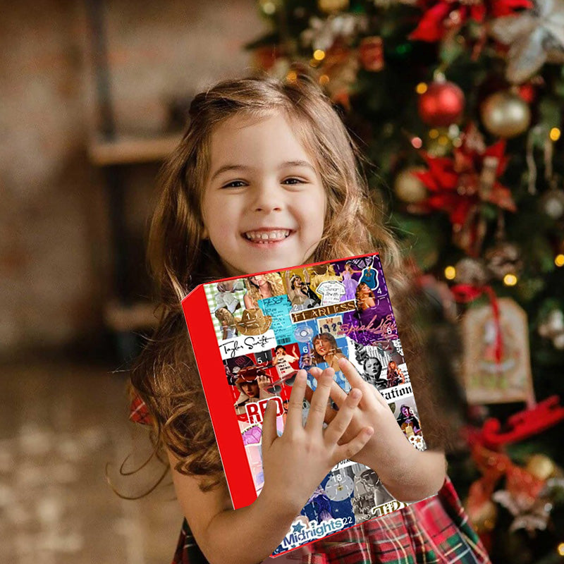 Child holding a red pop star charm advent calendar with numbered window grid