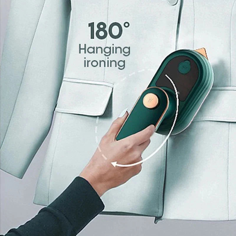 Green handheld steamer ironing hanging clothes, steam attachment pressed to fabric