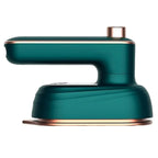 Green mini steam iron with copper-tone base and front steam plate