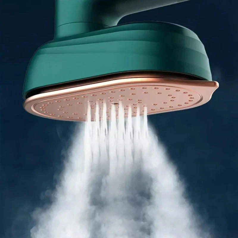 Close-up of green steam iron emitting steam from the soleplate