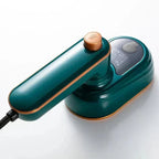 Green mini steam iron with dry and steam controls, copper temperature dial, compact handle