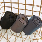 Thermal tights fabric rolls in black, gray, and taupe-brown