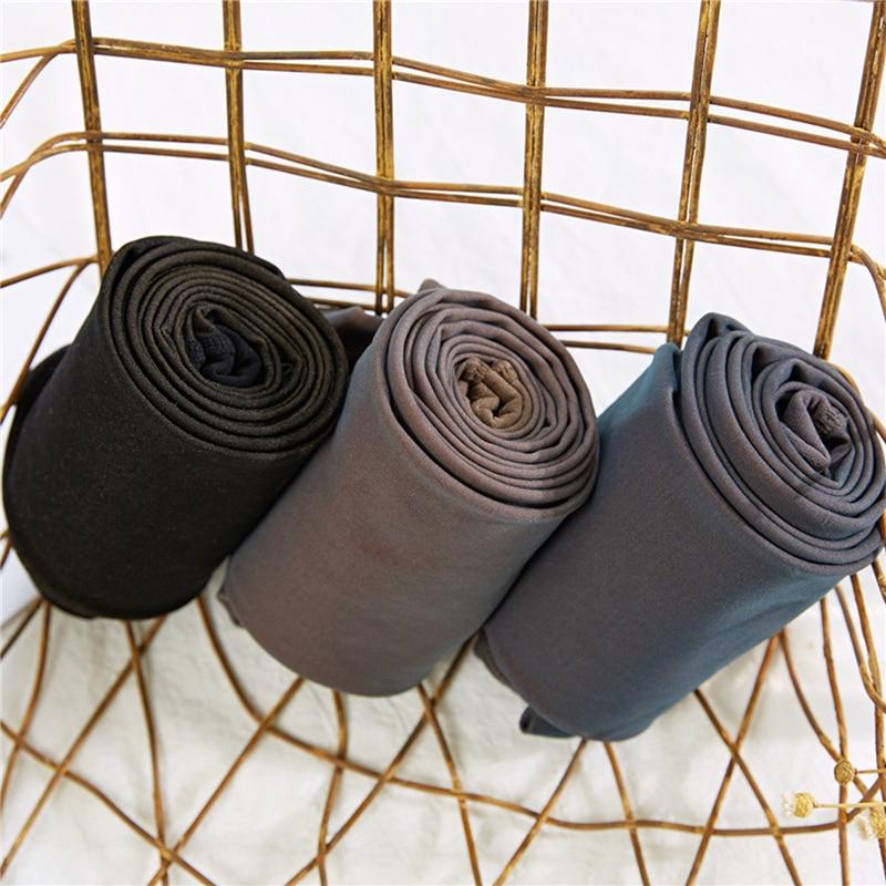 Thermal tights fabric rolls in black, gray, and taupe-brown